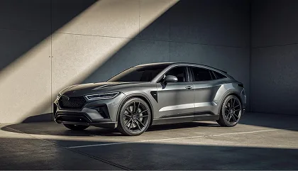 A grey coupe SUV photographed against a concrete wall