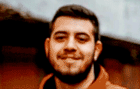 A still image of a man which has been turned into a video showing him blinking, smiling and moving his head.